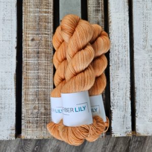 Three skeins of warm orange neutral coloured hand dyed yarn