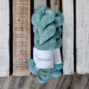 Three skeins of topaz blue coloured hand dyed yarn
