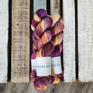 Three skeins of purple and yellow hand dyed yarn