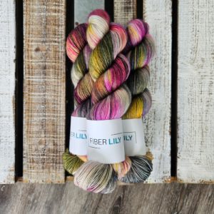 Three skeins of pink and green hand dyed yarn.