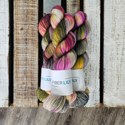 Three skeins of pink and green hand dyed yarn.