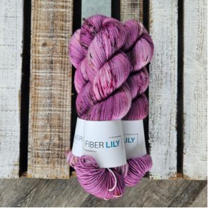 Three skeins of hand dyed wool dyed the colour of a berry milkshake